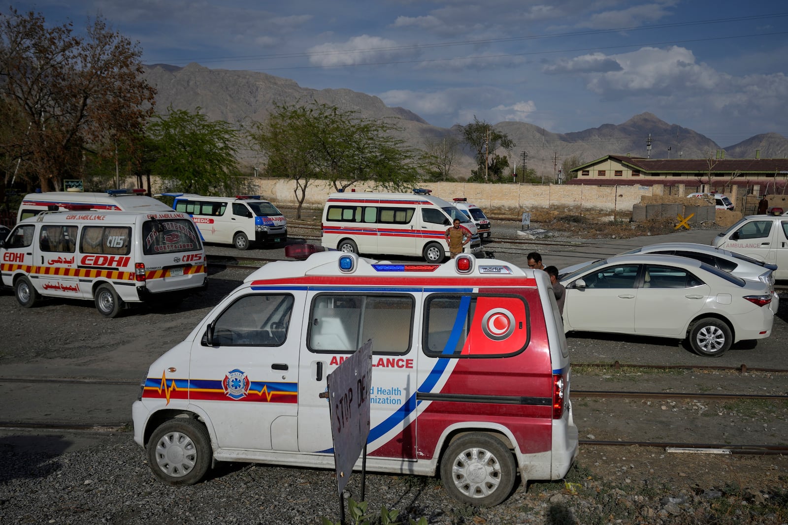 Ambulances park outside a railway station where rescued and injured passenger of a train attacked by insurgents are brought in Much, Pakistan's southwestern Balochistan province, Wednesday, March 12, 2025. (AP Photo/Anjum Naveed)