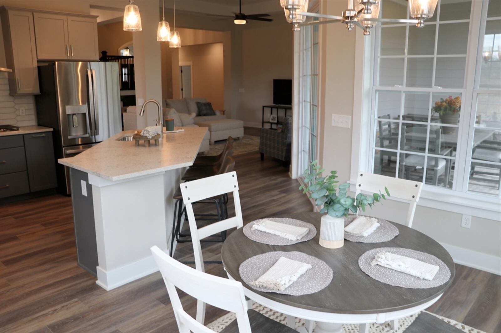 Large sliding patio doors set between the great room and breakfast room open to the covered patio, which is also accessible from the primary bedroom.