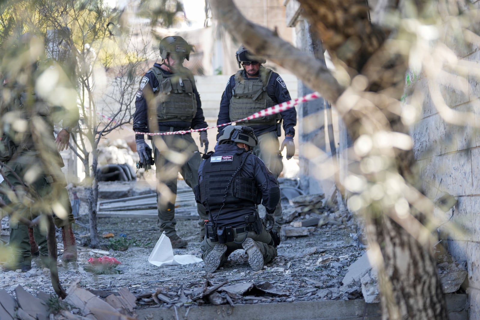 Members of the Israeli police bomb squad work at the site where one person was killed after a projectile launched from Lebanon slammed into Maalot-Tarshiha, northern Israel, Tuesday, Oct. 29, 2024. (AP Photo/Ohad Zwigenberg)