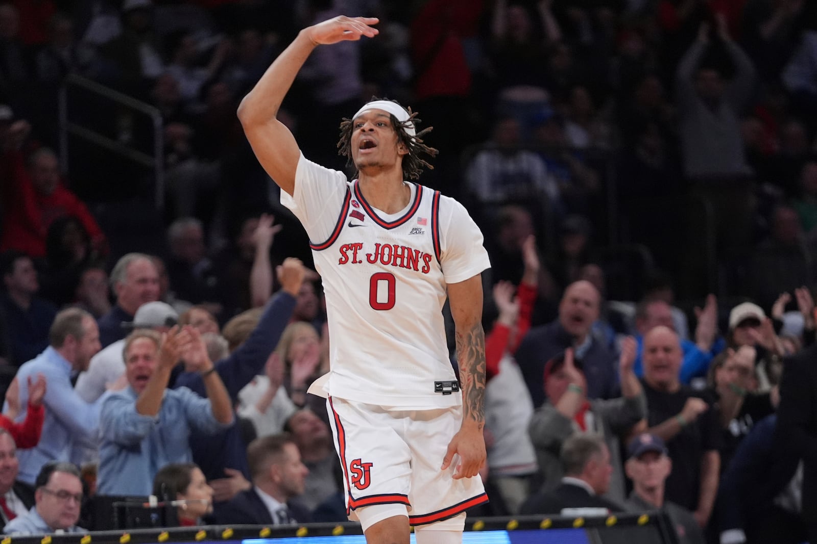 St. John's's Aaron Scott (0) celebrates after making a three-point shot during the second half of an NCAA college basketball game against the Marquette in the semifinals of the Big East tournament Friday, March 14, 2025, in New York. (AP Photo/Frank Franklin II)