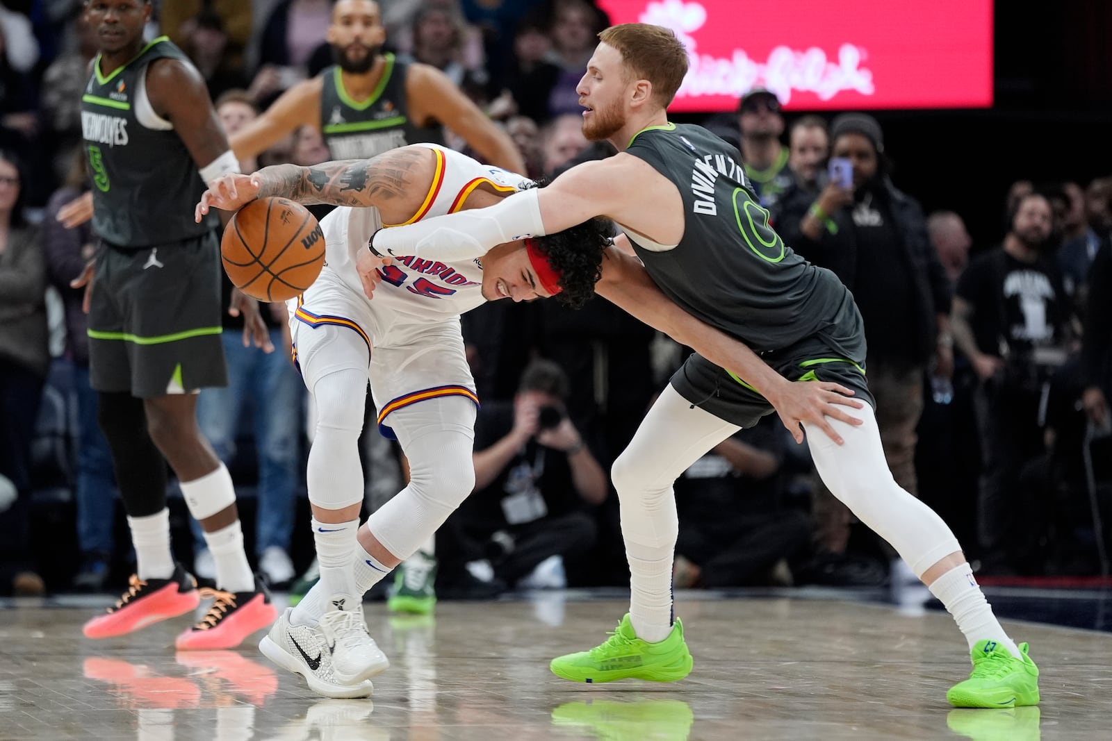 Golden State Warriors forward Gui Santos (15), left, handles the ball as Minnesota Timberwolves guard Donte DiVincenzo (0) defends during the second half of an NBA basketball game, Wednesday, Jan. 15, 2025, in Minneapolis. (AP Photo/Abbie Parr)