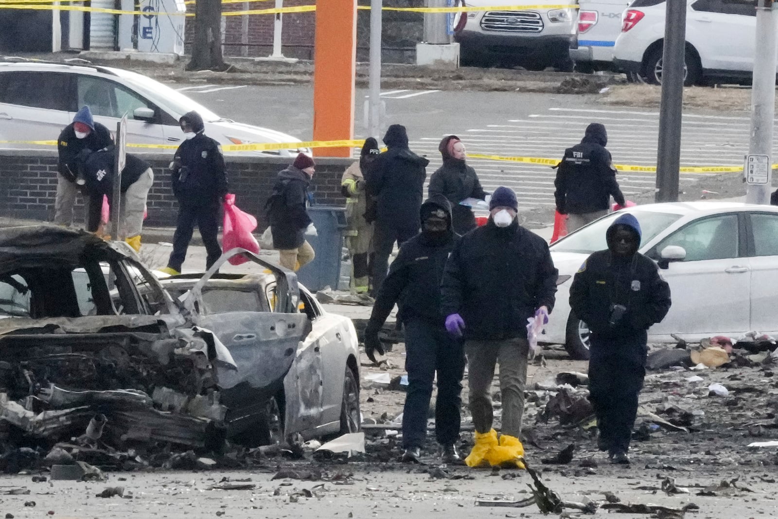 Investigators work the scene after a small plane crashed in Philadelphia, Saturday, Feb. 1, 2025. (AP Photo/Matt Rourke)