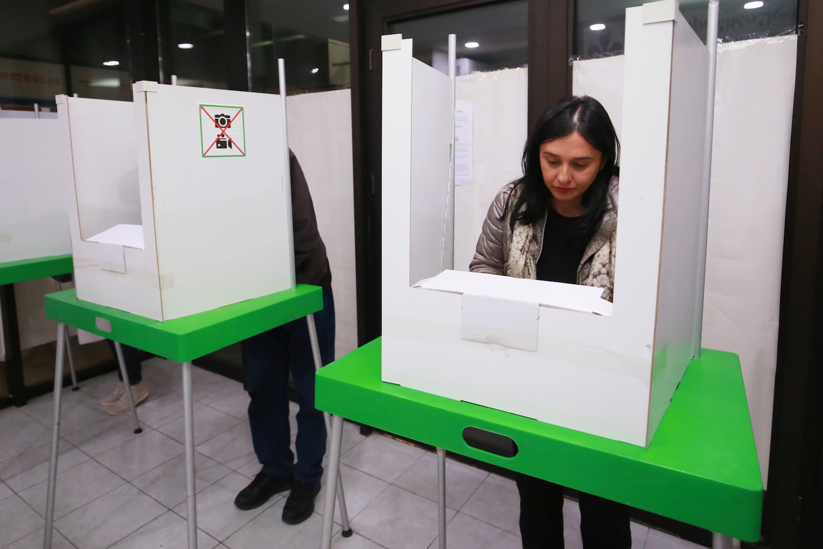 People fill their ballots at a polling station during the parliamentary election in Tbilisi, Georgia, Saturday, Oct. 26, 2024. (AP Photo/Zurab Tsertsvadze)