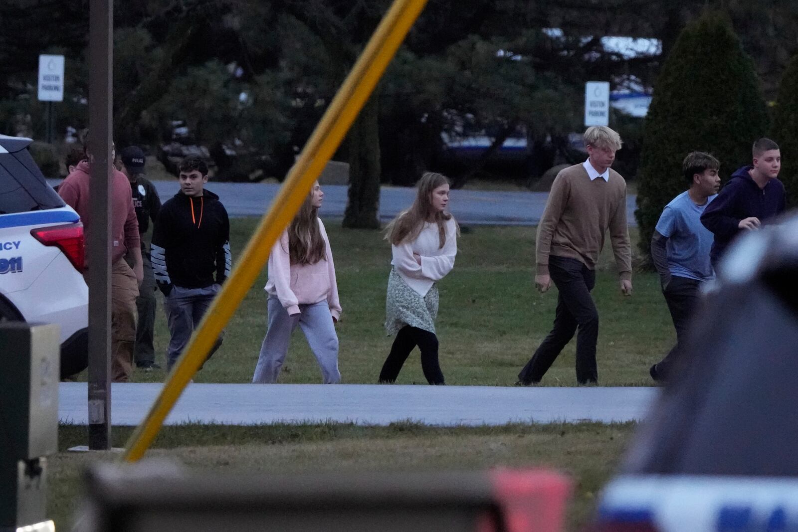 Students walk to a bus as they leave the shelter following a shooting at the Abundant Life Christian School, Monday, Dec. 16, 2024. (AP Photo/Morry Gash)