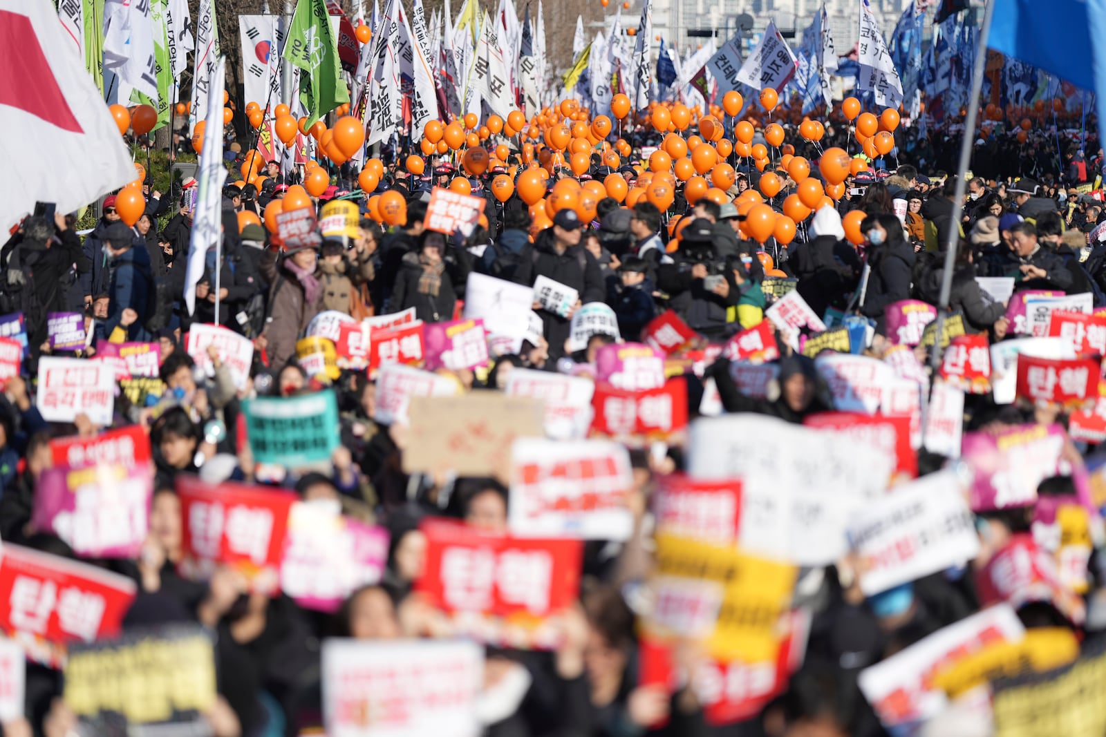 People march for a rally to demand South Korean President Yoon Suk Yeol's impeachment outside the National Assembly in Seoul, South Korea, Saturday, Dec. 14, 2024. (AP Photo/Lee Jin-man)