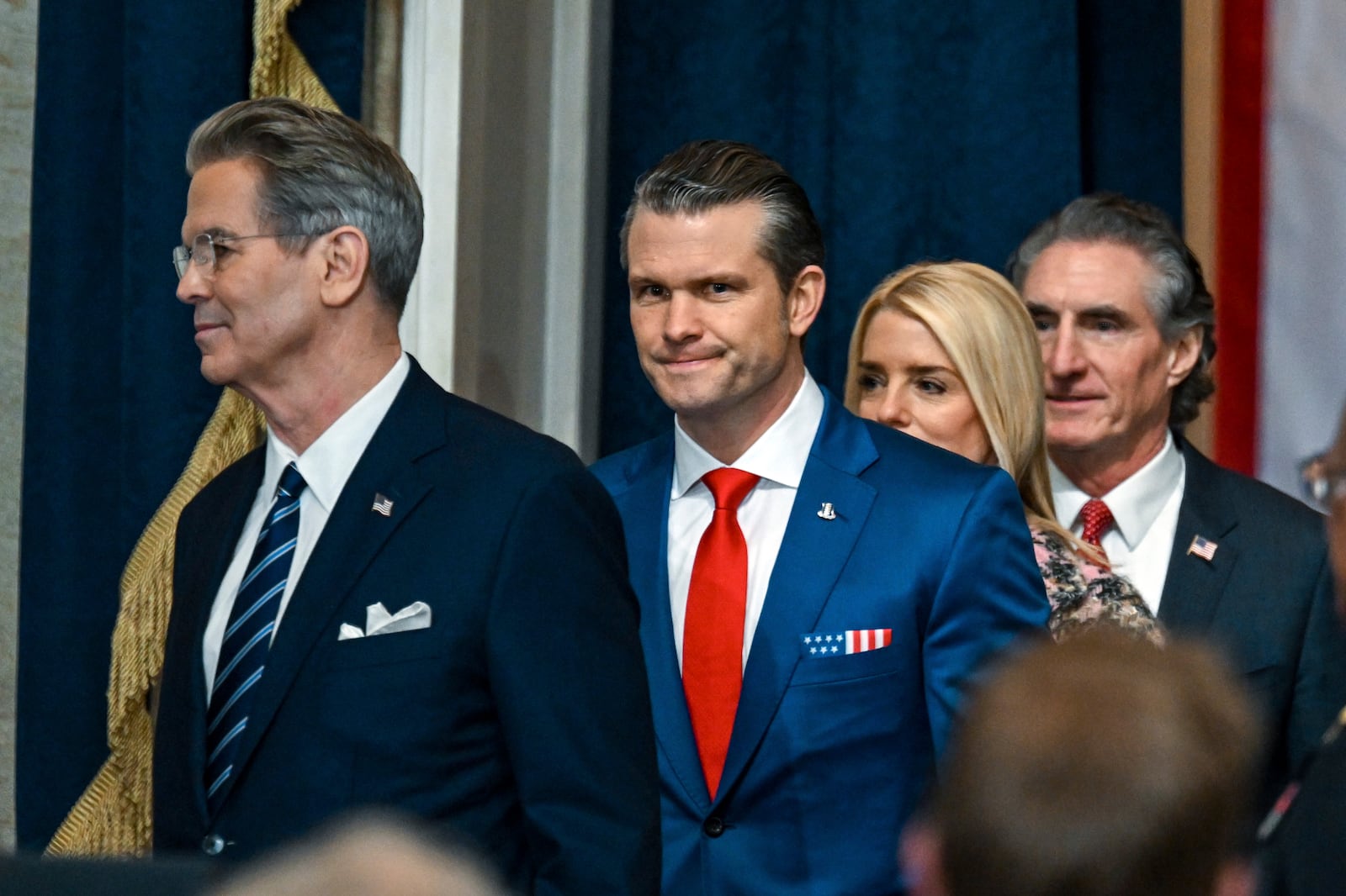 Defense Secretary nominee Pete Hegseth, from second left, Attorney General nominee Pam Bondi and Secretary of the Interior nominee former North Dakota Gov. Doug Burgum, arrive before the 60th Presidential Inauguration in the Rotunda of the U.S. Capitol in Washington, Monday, Jan. 20, 2025. (Kenny Holston/The New York Times via AP, Pool)