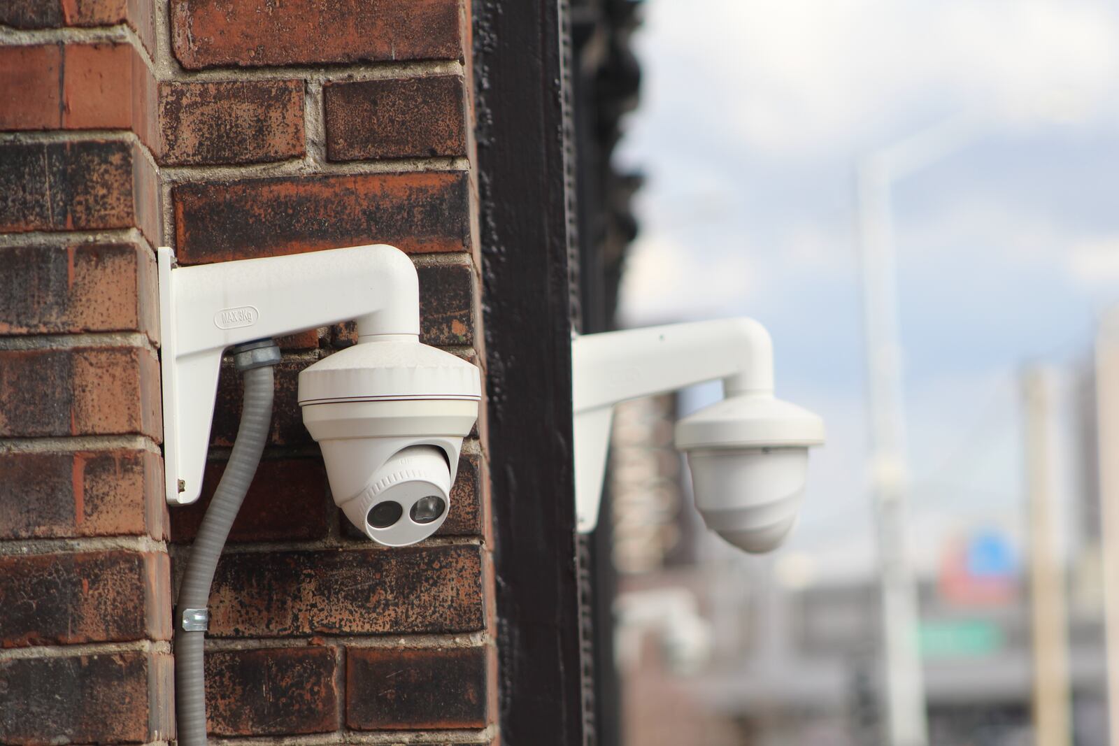 Security cameras on the front of a building on East Third Street in the Webster Station neighborhood. CORNELIUS FROLIK / STAFF