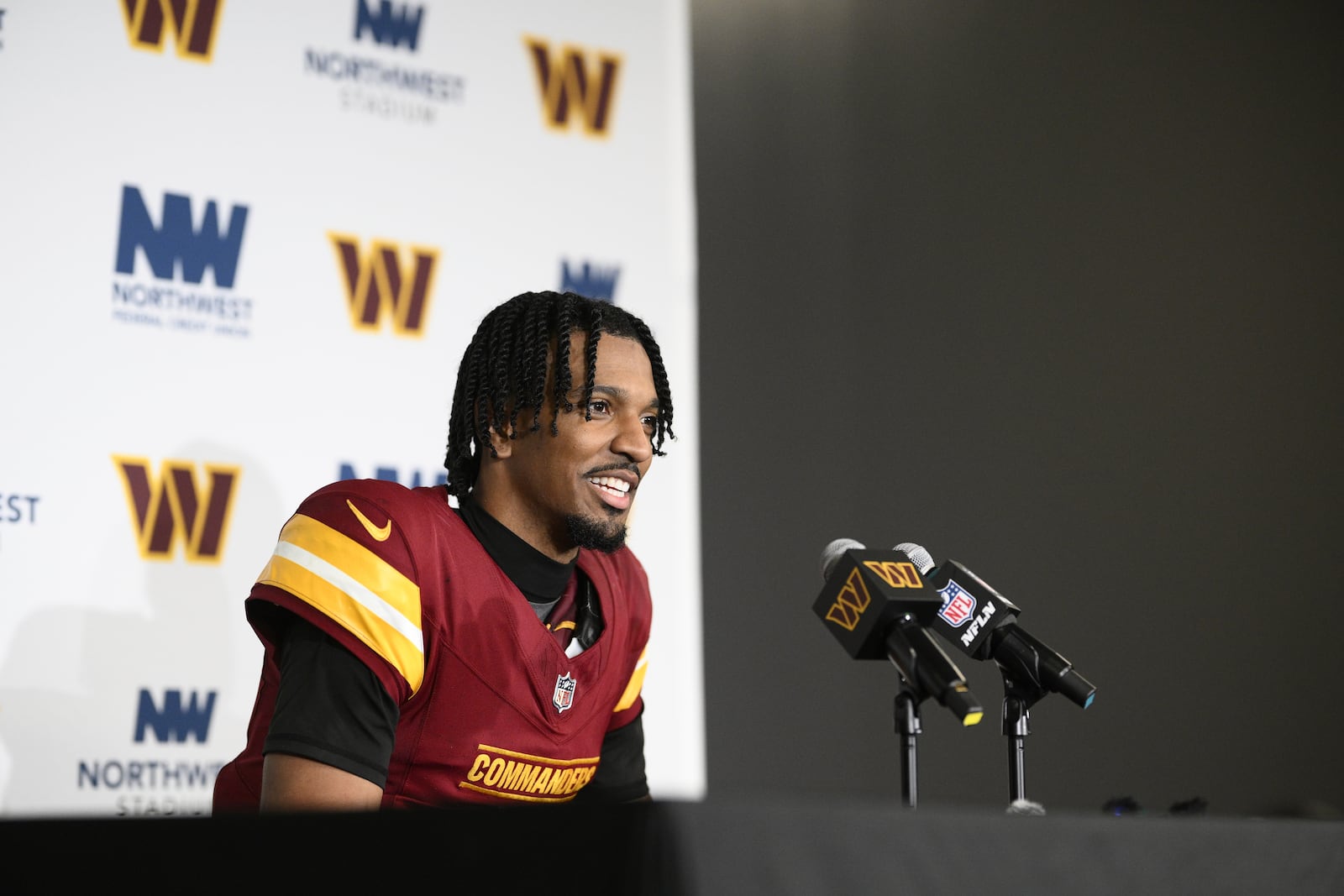 Washington Commanders quarterback Jayden Daniels (5) talks to reporters after an NFL football game against the Atlanta Falcons, Sunday, Dec. 29, 2024, in Landover, Md. The Commanders won in overtime 30-24. (AP Photo/Nick Wass)