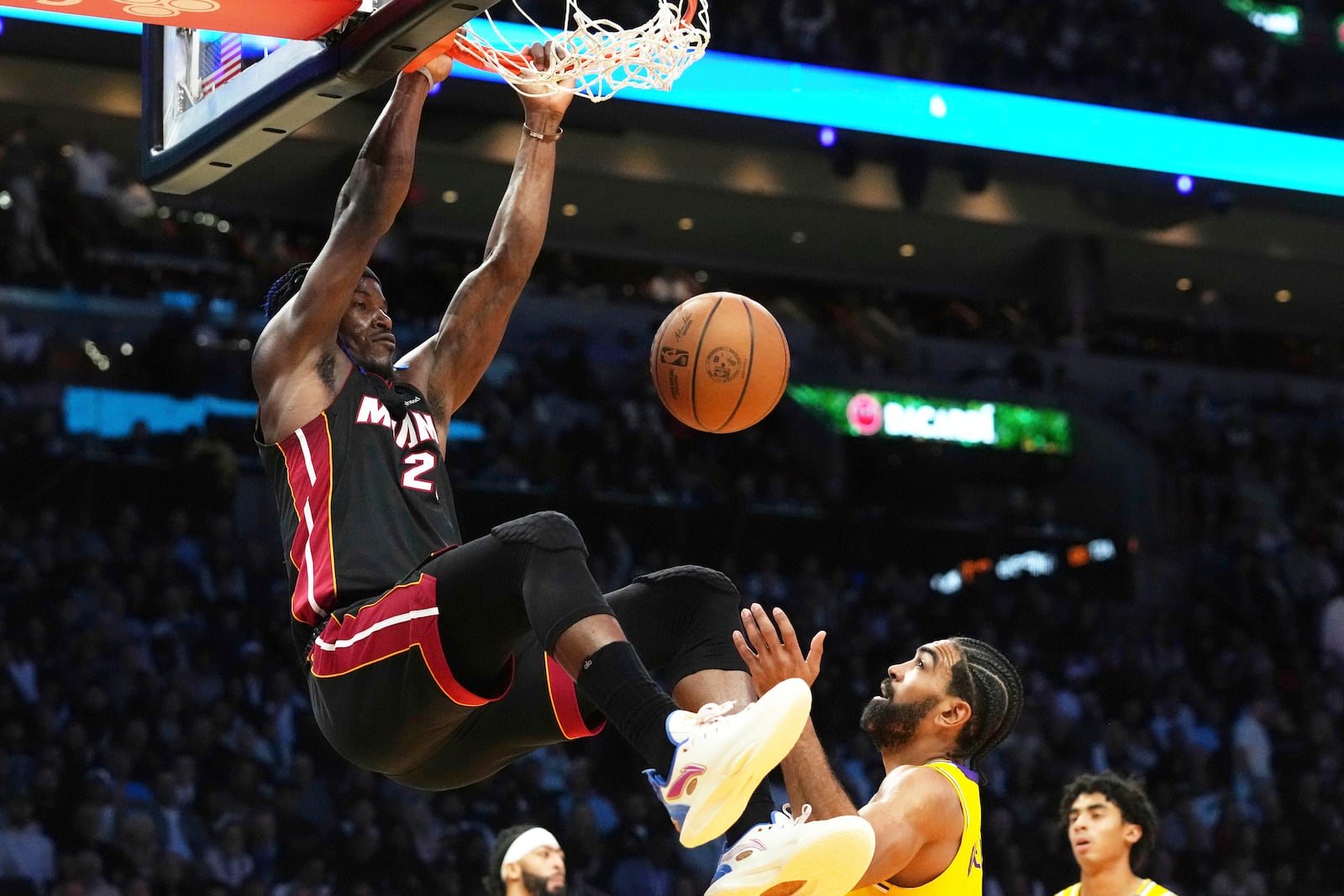 Miami Heat forward Jimmy Butler (22) dunks the ball over Los Angeles Lakers guard Gabe Vincent (7) during the second half of an NBA basketball game, Wednesday, Dec. 4, 2024, in Miami. (AP Photo/Marta Lavandier)