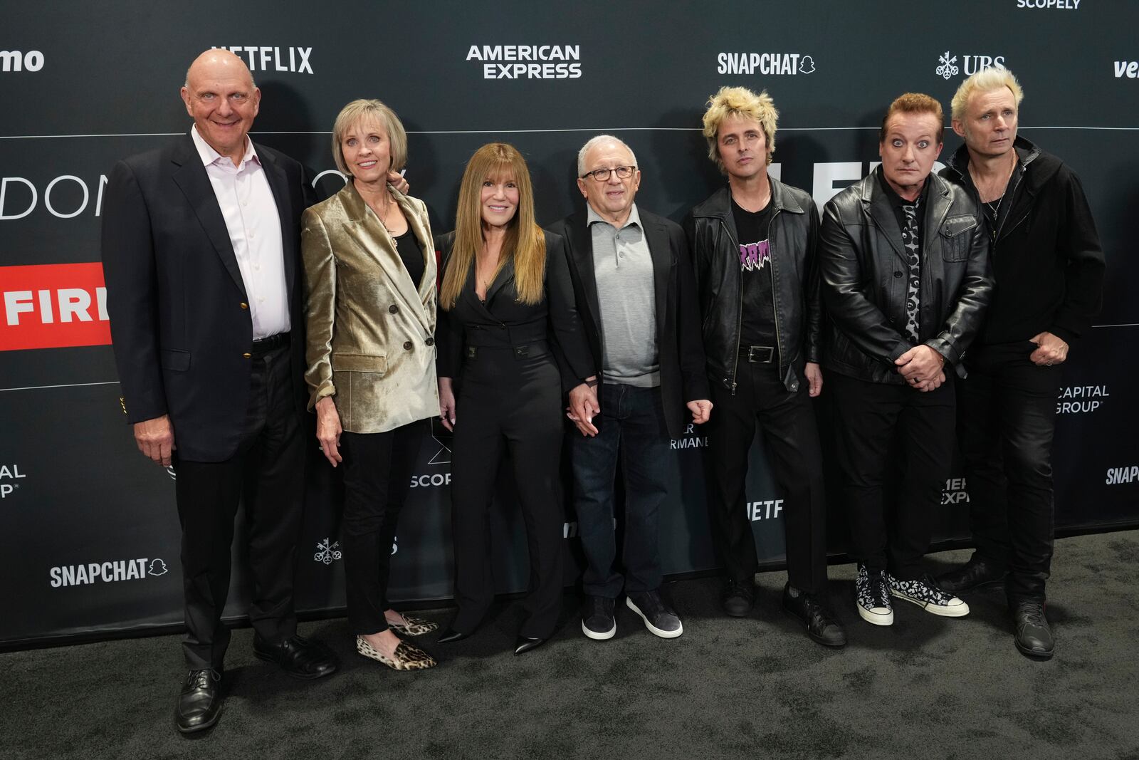 Steve Ballmer, from left, Connie Snyder, Shelli Azoff, and Irving Azoff, pose with Billie Joe Armstrong, Tre Cool, and Mike Dirnt of Green Day upon arrival at the FireAid benefit concert on Thursday, Jan. 30, 2025, at Intuit Dome in Inglewood, Calif. (Photo by Jordan Strauss/Invision/AP)