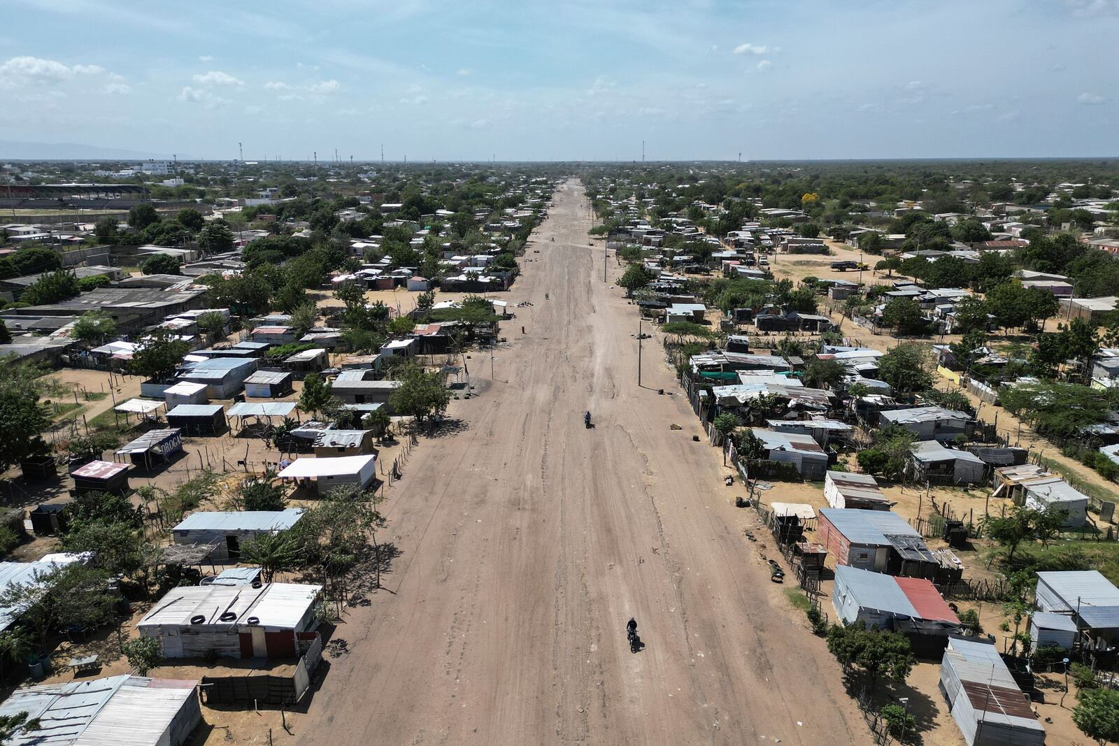 Homes stand near a clearing on the outskirts of Maicao, Colombia, Wednesday, Feb. 5, 2025. (AP Photo/Ivan Valencia)