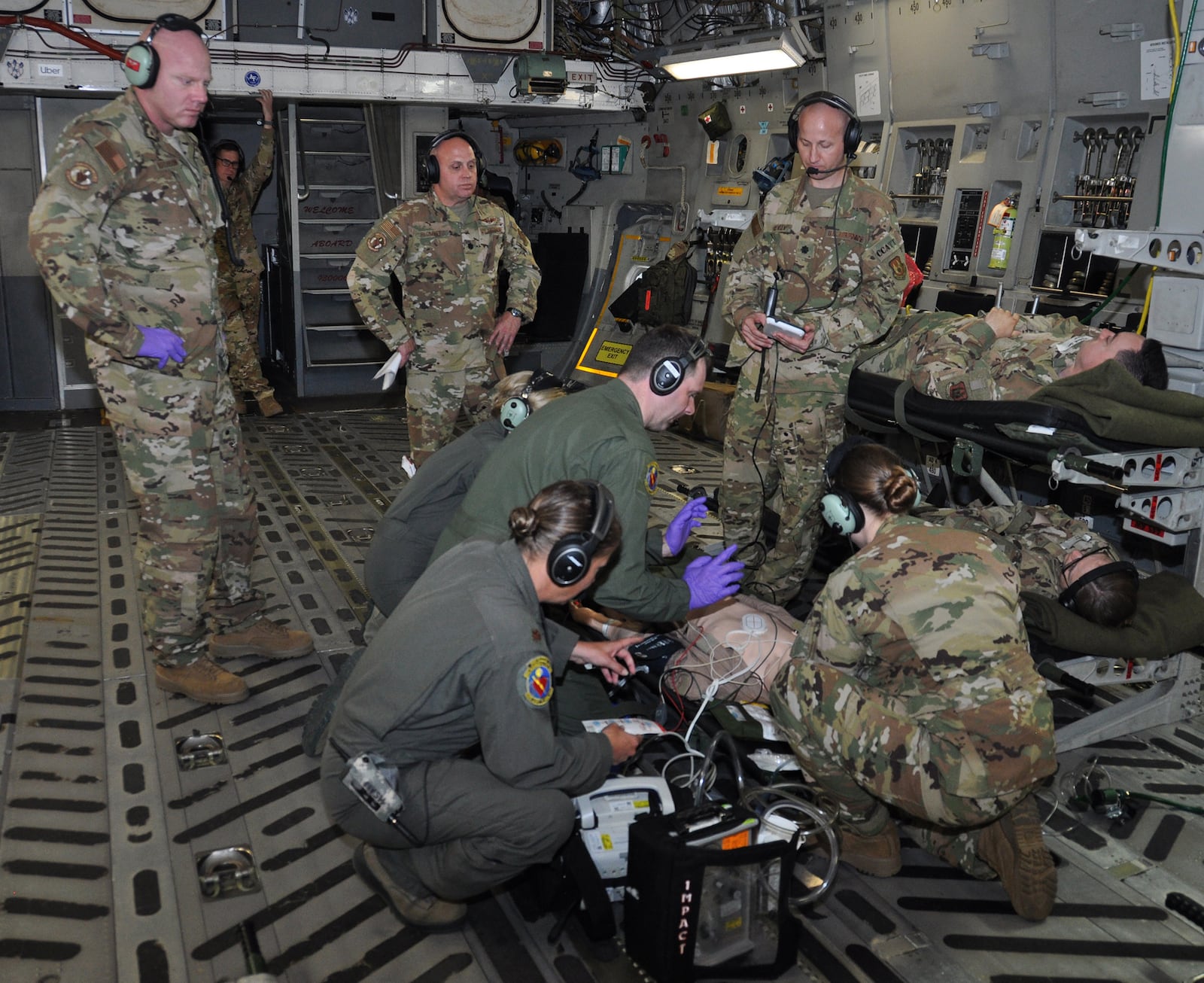 Lt. Col. Derek Sorensen, (standing far right) U.S. Air Force School of Aerospace Medicine medical director for en route care training, evaluates a 445th Aeromedical Evacuation Squadron crew during an AE readiness flight, May 8, 2019. (U.S. Air Force photo/Staff Sgt. Darrell Sydnor)