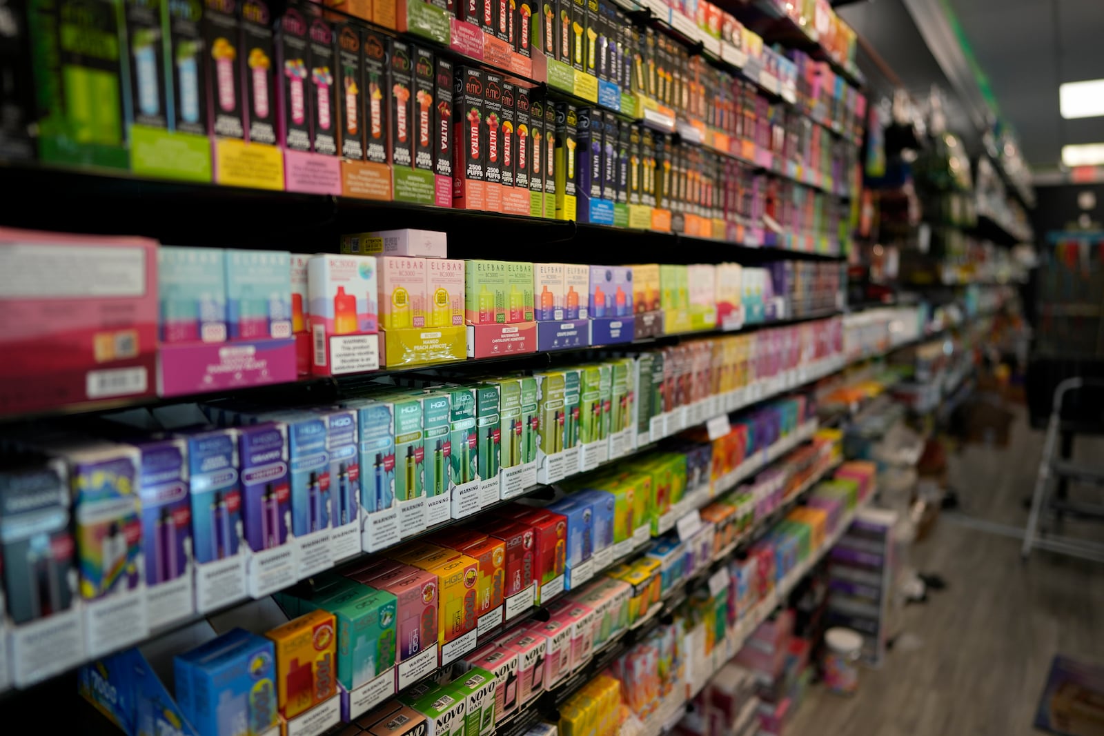 Disposable electronic cigarette devices from brands including HQD and Elf Bar, now known as EB Designs, are displayed for sale at Vapes N Smoke in Pinecrest, Fla., Monday, June 26, 2023. Since 2020, the number of different e-cigarette devices for sale in the U.S. has exploded to more than 9,000, a nearly three-fold increase driven almost entirely by a wave of disposable vapes from China. (AP Photo/Rebecca Blackwell)