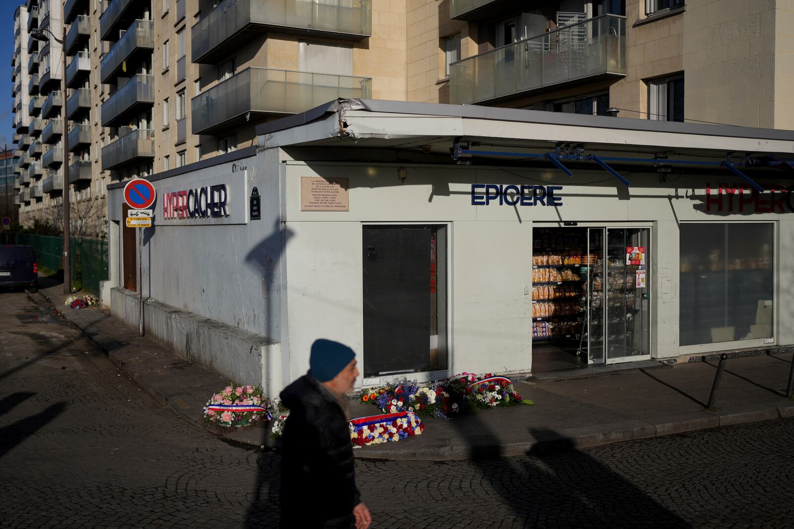 Wreaths lie in front of the Hypercacher Supermarket after commemorations marking 10 years since an Islamist attack on the Charlie Hebdo satirical newspaper and the Hypercacher jewish supermarket, in Paris Tuesday Jan. 7, 2025. (AP Photo/Thibault Camus)