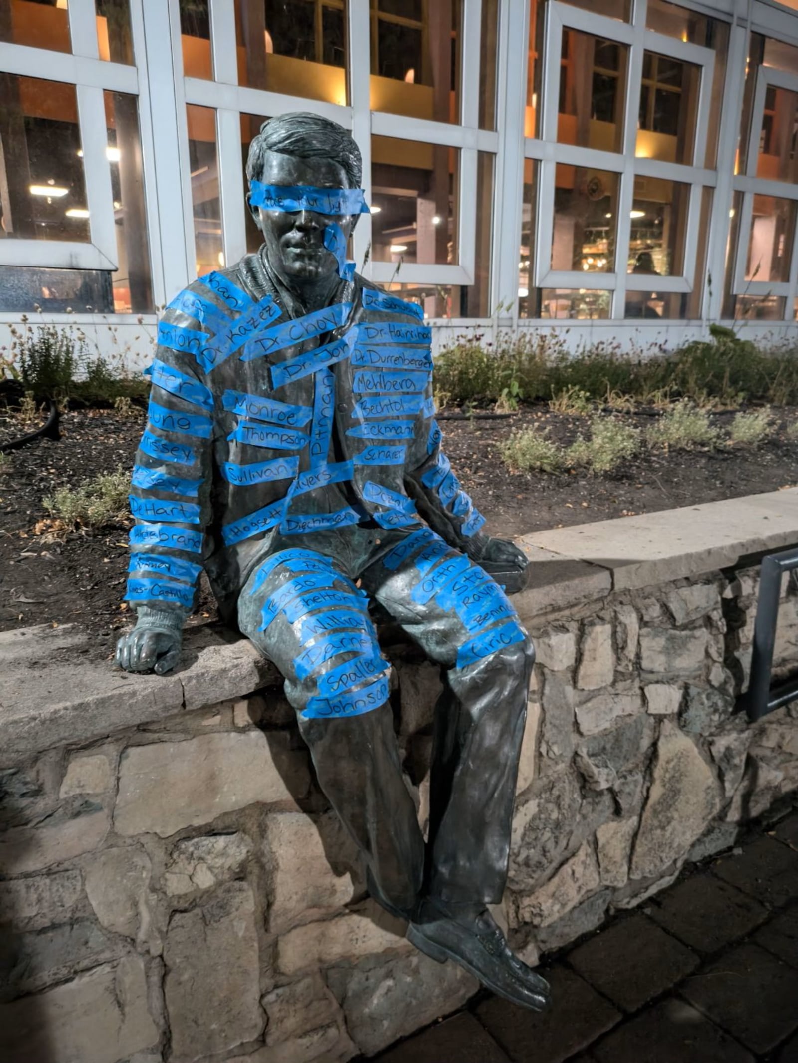 The Wally Witt statue outside Wittenberg University's student center is covered with tape strips bearing names of faculty and others on a recent night, as the school prepares to announce faculty and staff reductions in September 2024. CONTRIBUTED PHOTO