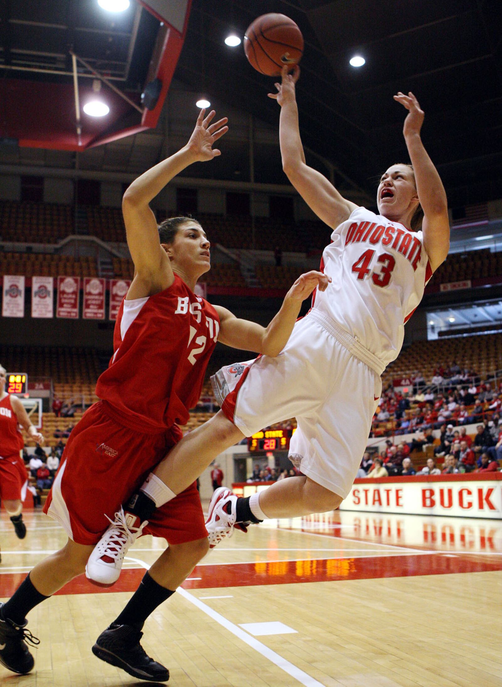 Ohio State's Sarah Schulze (43) is fouled by Boston's Christine Kinneary (12) during the second half of an NCAA college basketball game Saturday, Nov. 29, 2008, in Columbus, Ohio. (AP Photo/Terry Gilliam)