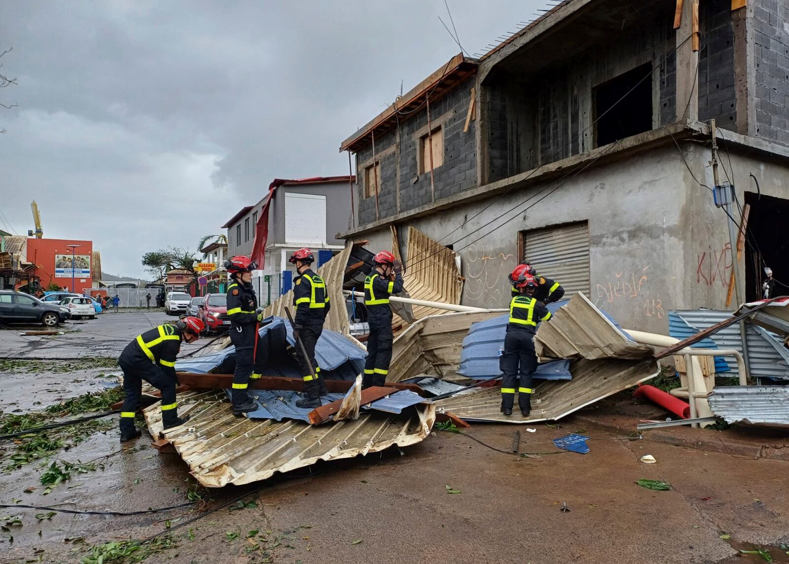 This photo provided Sunday Dec.15, 2024 by the Civil Security shows rescue workers clearing an area in the French territory of Mayotte in the Indian Ocean, after Cyclone Chido caused extensive damage with reports of several fatalities, Saturday Dec.14, 2024. (UIISC7/Securite civile via AP)