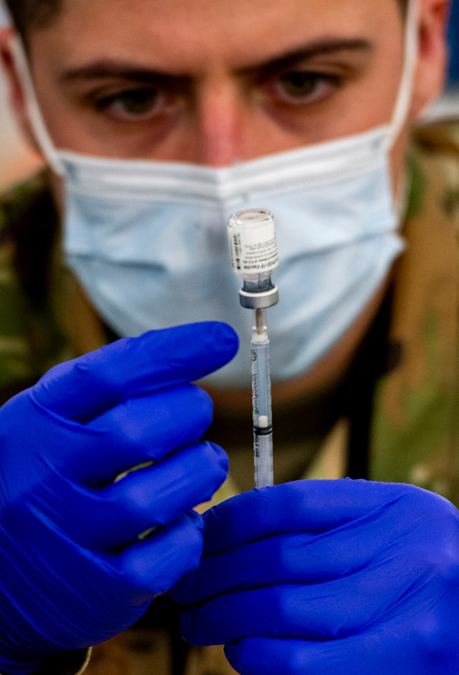 An Airman fills a syringe with the COVID-19 vaccine May 3 inside the community vaccination center’s pharmacy at Ford Field in Detroit. U.S. AIR FORCE PHOTO/WESLEY FARNSWORTH