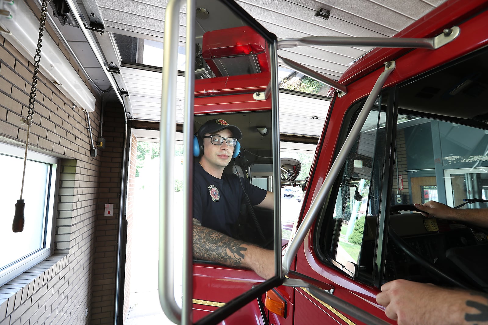 Springfield fire fighter Skyler Baise checks his mirrors as he backs the fire engine into the tiny garage bay at Fire Station #3. That station could be replaced as the city looks to build three new fire stations. BILL LACKEY/STAFF