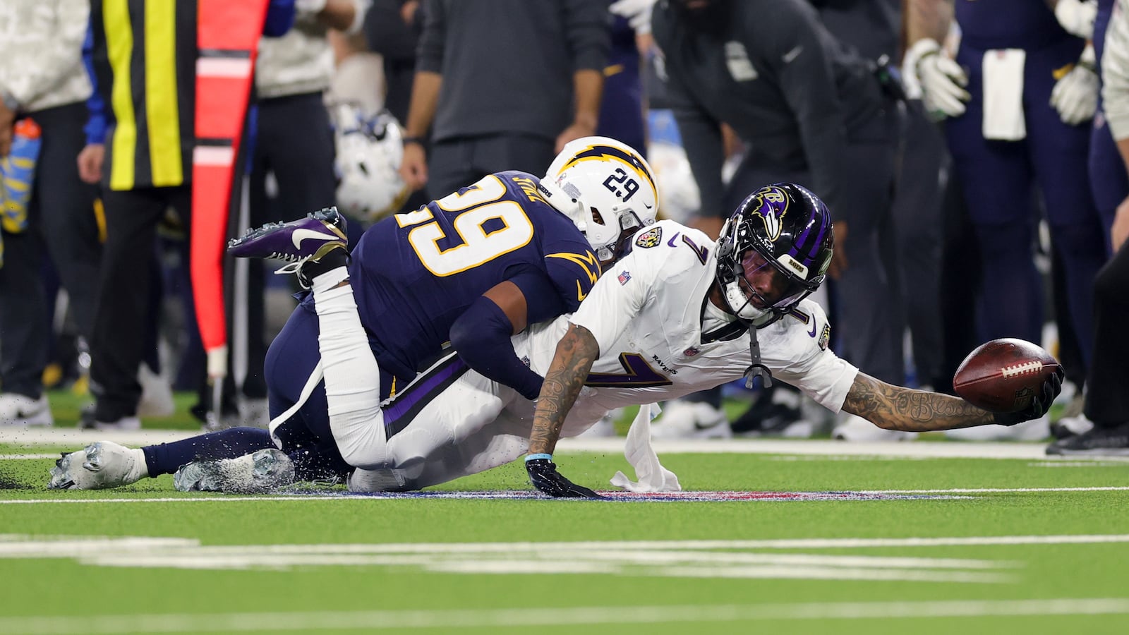 Baltimore Ravens wide receiver Rashod Bateman (7) reaches for a first down as Los Angeles Chargers cornerback Tarheeb Still (29) defends during the second half of an NFL football game Monday, Nov. 25, 2024, in Inglewood, Calif. (AP Photo/Ryan Sun)