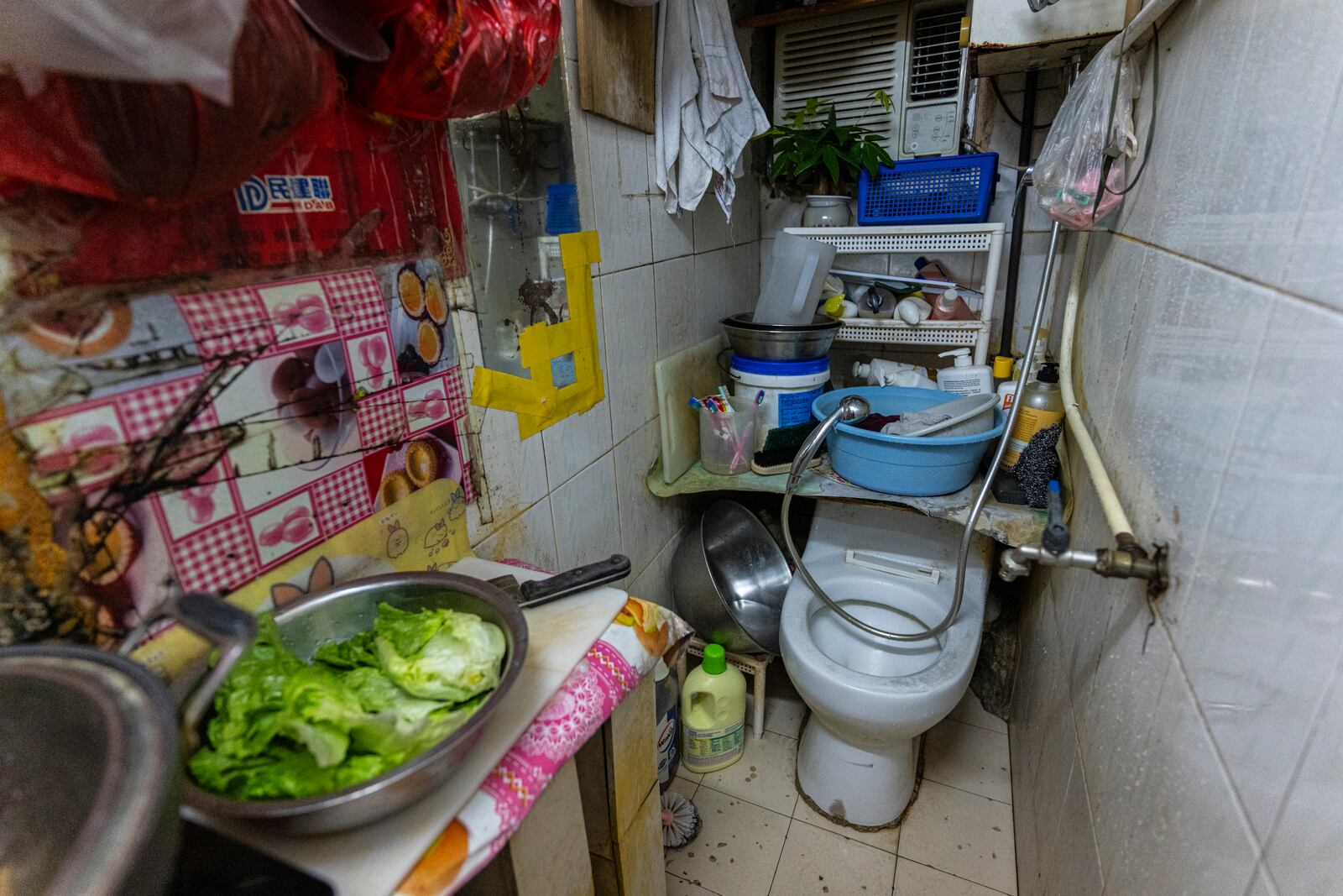 A toilet and kitchen are located in the same area of a subdivided flat in Sham Shui Po district of Hong Kong, on Feb. 6, 2025. (AP Photo/Chan Long Hei)