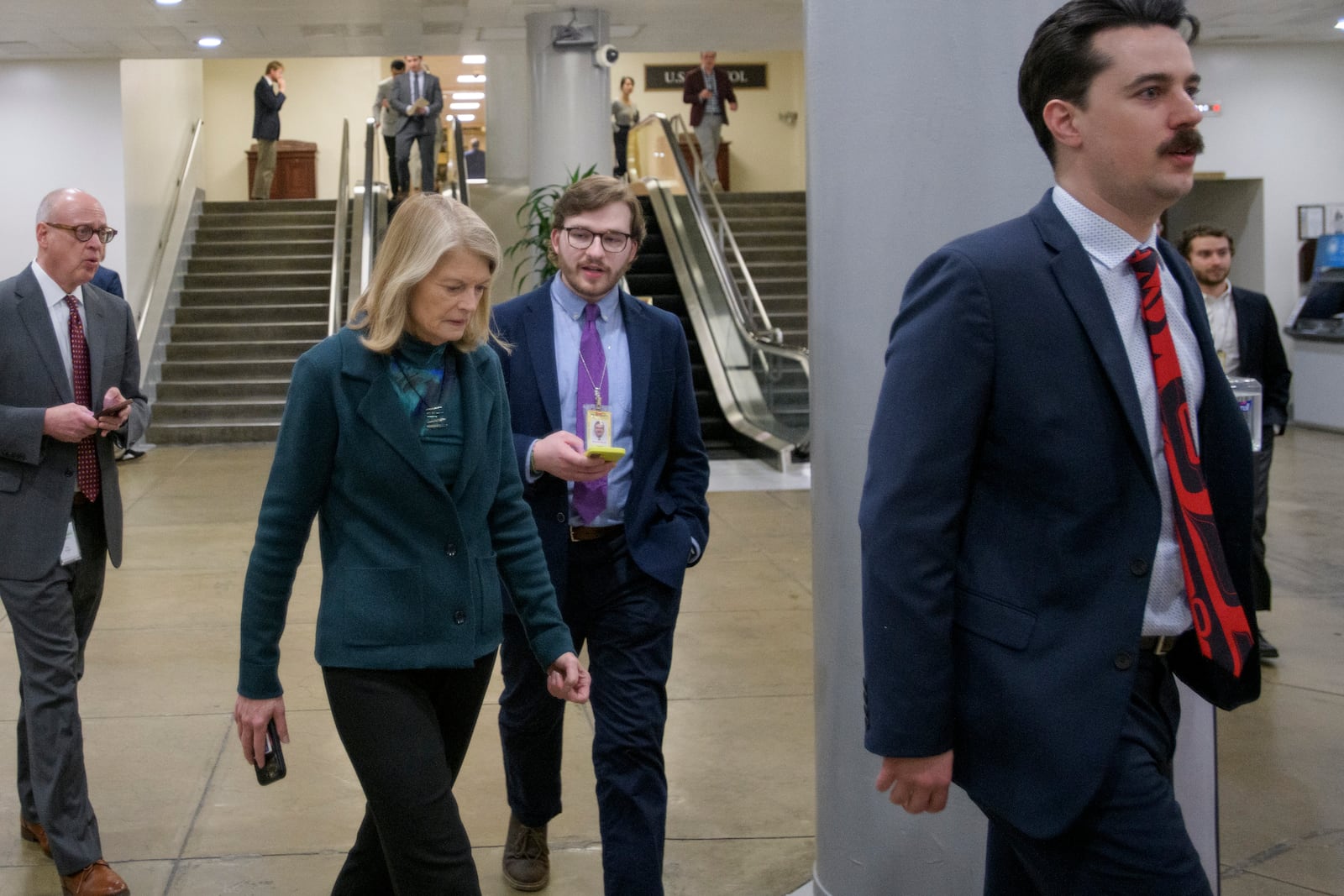 Sen. Lisa Murkowski, R-Alaska, talks with reporters as she makes her way through the Senate subway at the Capitol, Thursday, Jan. 23, 2025, in Washington. (AP Photo/Rod Lamkey, Jr.)