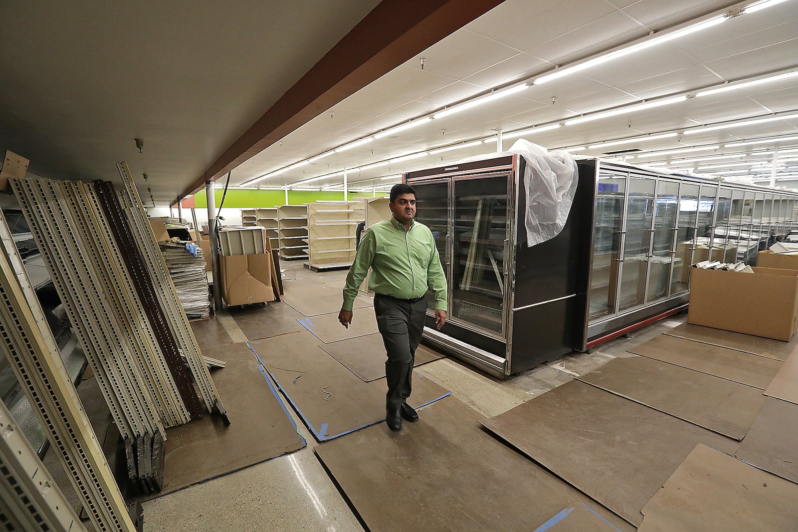 Ravi Patel, president of Groceryland Inc., walks through the future Groceryland location still under construction on South Limestone Street Wednesday. BILL LACKEY/STAFF