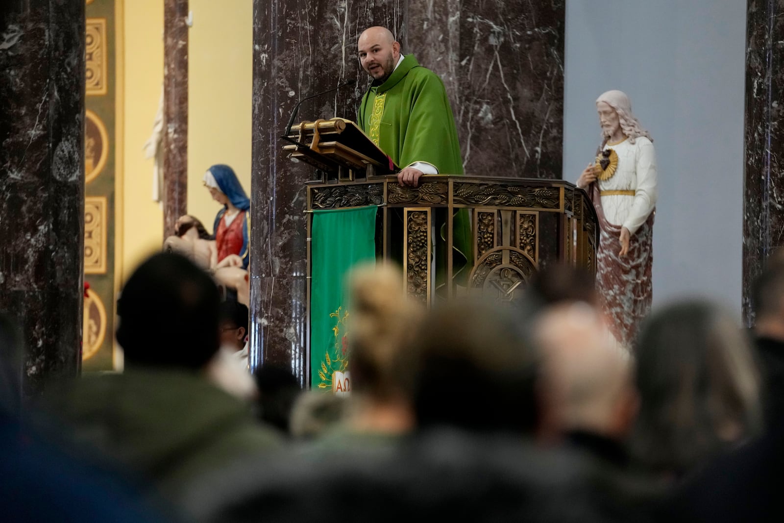 Priest Homero Sanchez speaks during a service at St. Rita of Cascia Parish in Chicago, Sunday, Jan. 19, 2025. (AP Photo/Nam Y. Huh)