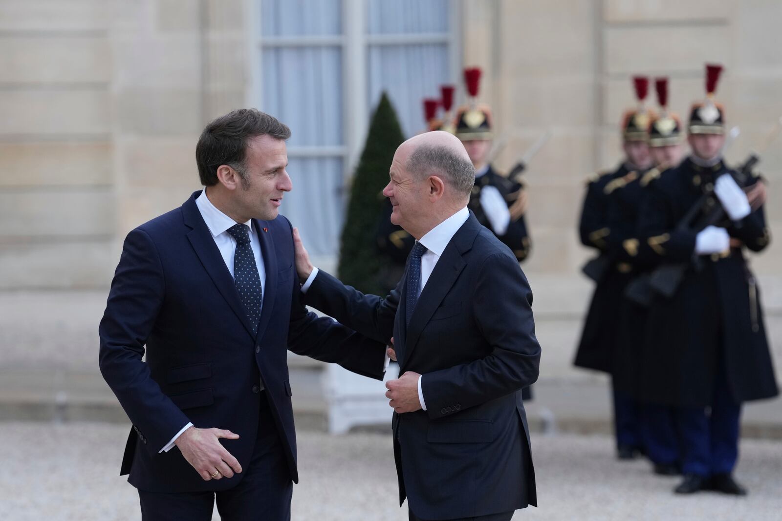 French President Emmanuel Macron, left, greets Germany's Chancellor Olaf Scholz as he arrives for an informal meeting of leaders from key European Union nations and the United Kingdom at the Elysee Palace in Paris, Monday, Feb. 17, 2025. (AP Photo/Aurelien Morissard)