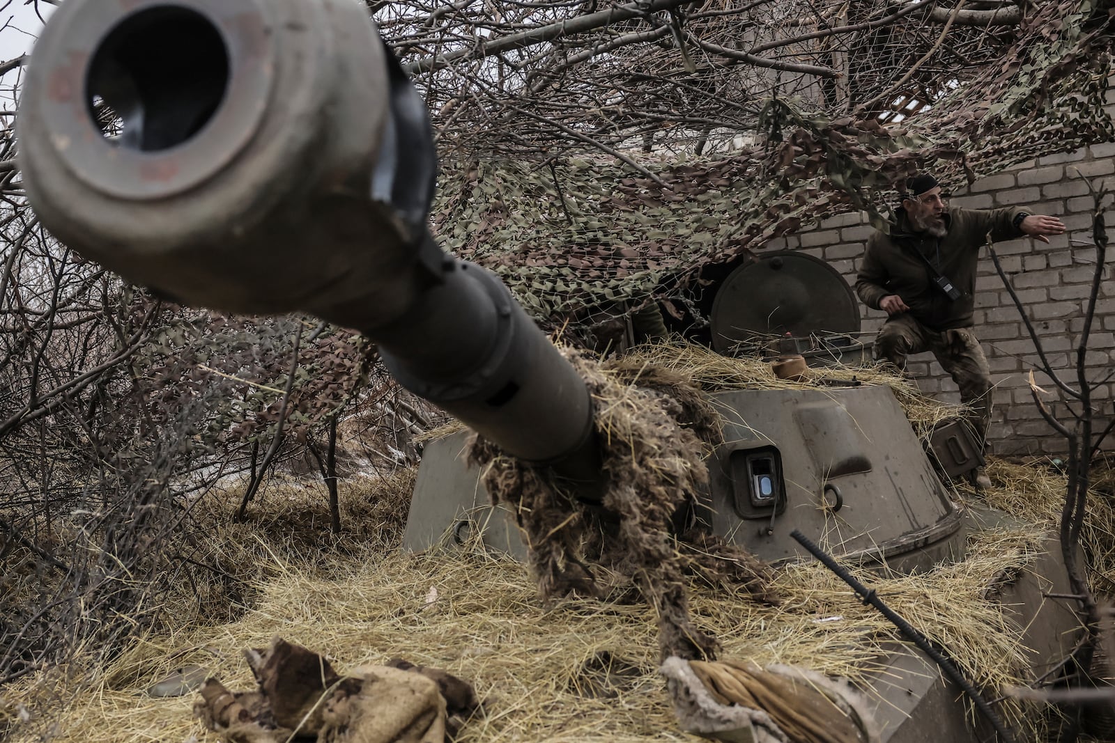 FILE - In this photo provided by Ukraine's 24th Mechanized Brigade press service, a soldier prepares to fire a howitzer towards Russian positions on the front line near Chasiv Yar, Donetsk region, Ukraine, Friday, Feb. 7, 2025. (Oleg Petrasiuk/Ukraine's 24th Mechanized Brigade via AP, File)