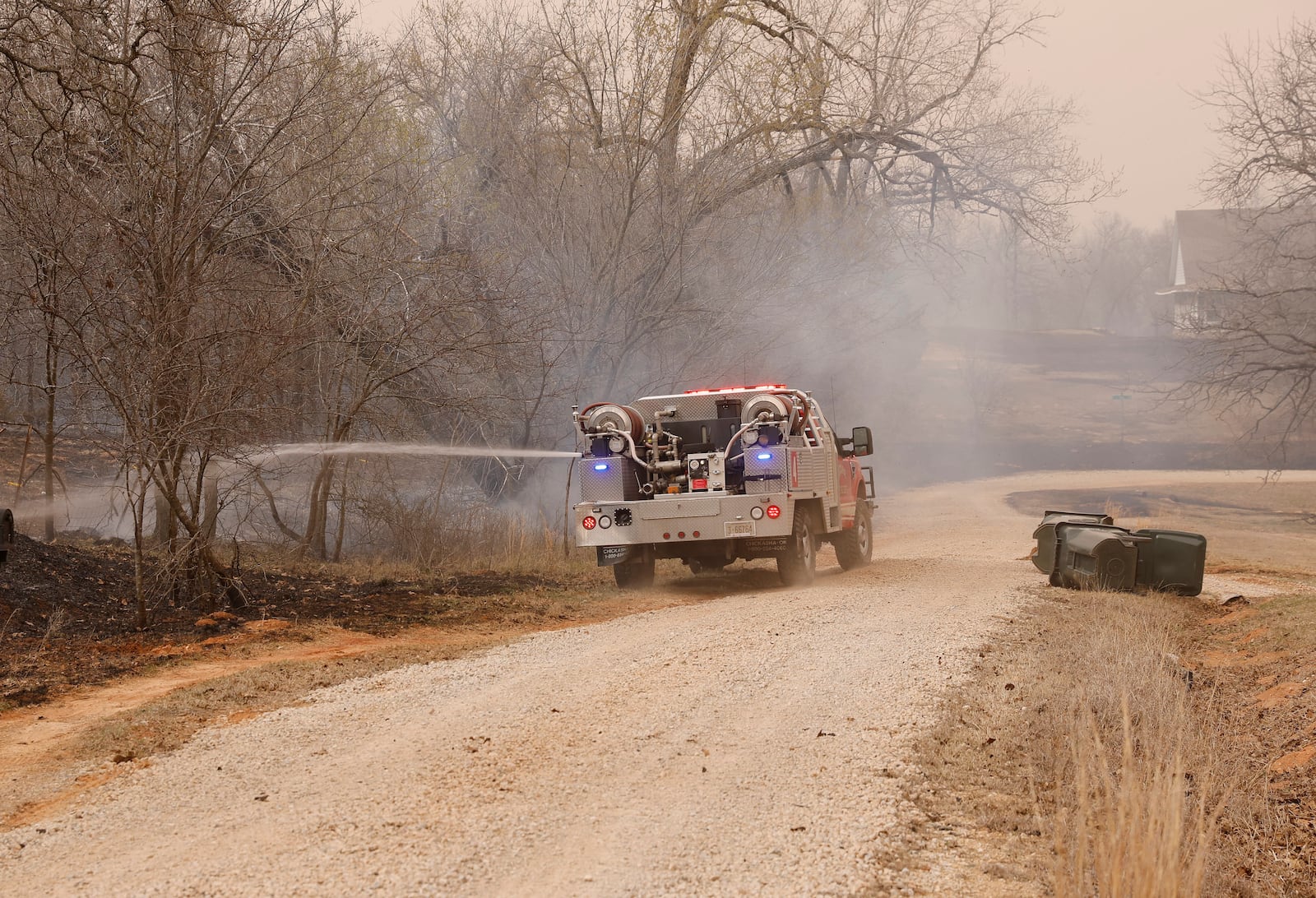 Norman Oklahoma fire crews put out hot spots following a wildfire SE of Norman on Friday, March 14, 2025. (AP Photo/Alonzo Adams)