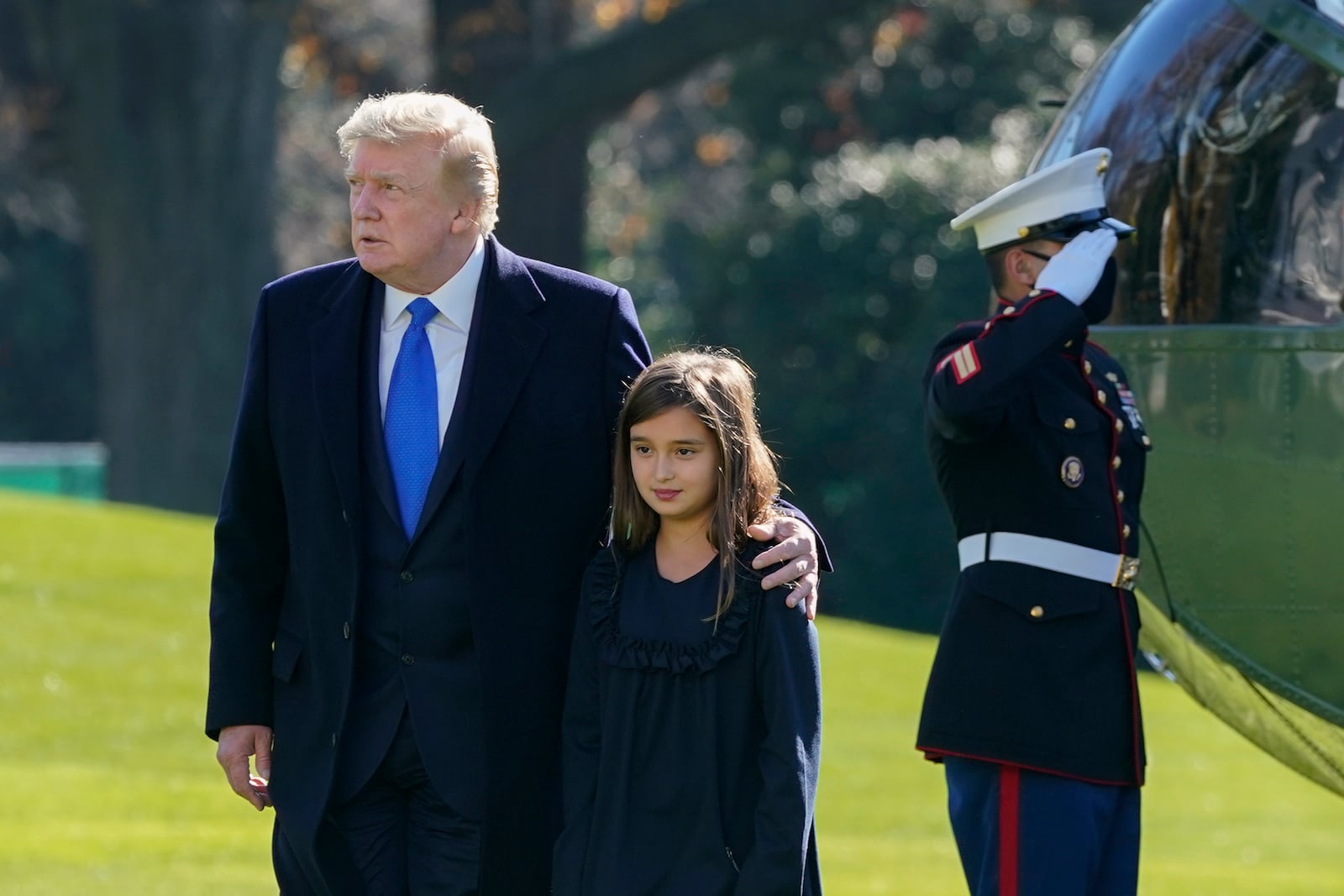 FILE - President Donald Trump walks with his granddaughter Arabella Kushner on the South Lawn of the White House in Washington, Nov. 29, 2020, after stepping off Marine One. (AP Photo/Patrick Semansky, File)