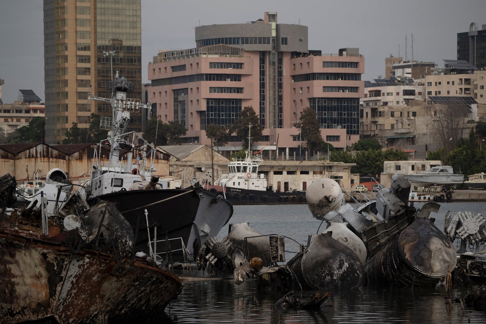 Destroyed Syrian naval vessels from previous Israeli airstrikes are seen in the port of Latakia, Syria, Monday, Dec. 16, 2024. (AP Photo/Leo Correa)