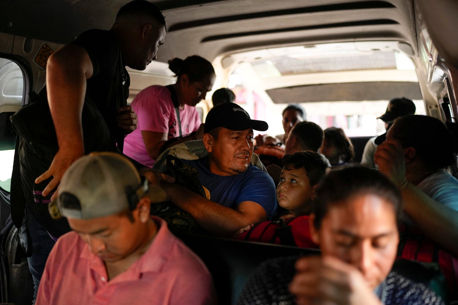 Honduran migrant Luis Alonso Valle, center, sits in a car to Tapachula in Ciudad Hidalgo, Mexico, after crossing the Suchiate River with his family from Guatemala, Monday, Oct. 28, 2024. (AP Photo/Matias Delacroix)