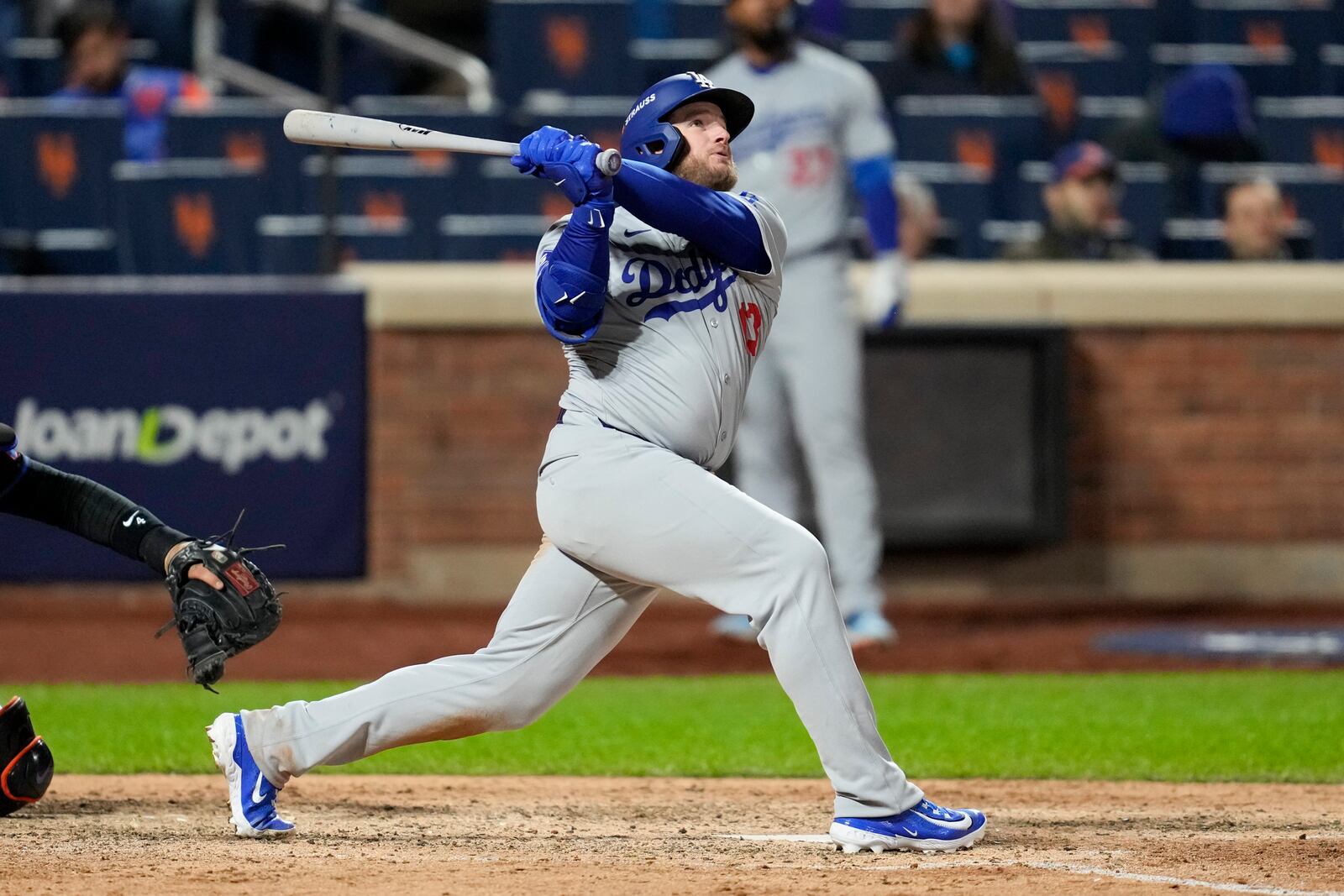 Los Angeles Dodgers' Max Muncy watches his home run against the New York Mets during the ninth inning in Game 3 of a baseball NL Championship Series, Wednesday, Oct. 16, 2024, in New York. (AP Photo/Ashley Landis)