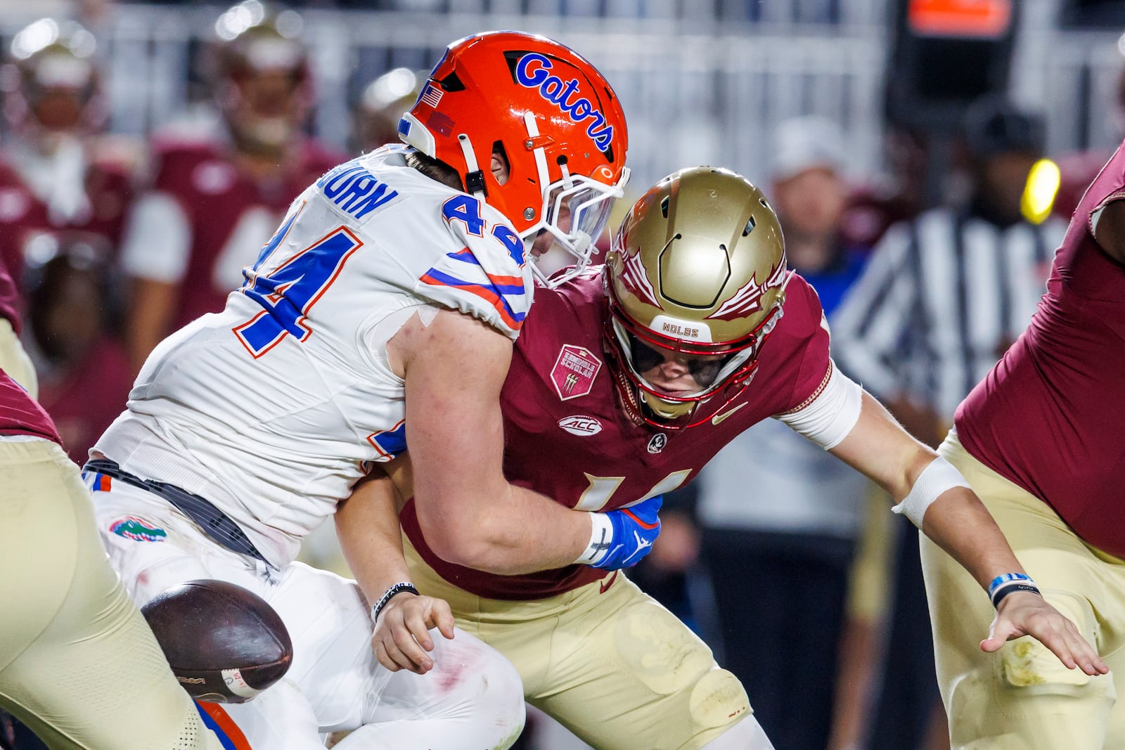 Florida's Jack Pyburn (44) strips the ball from Florida State quarterback Luke Kromenhoek, right, during the first half of an NCAA college football game Saturday, Nov. 30, 2024, in Tallahassee, Fla. Florida recovered the ball. (AP Photo/Colin Hackley)