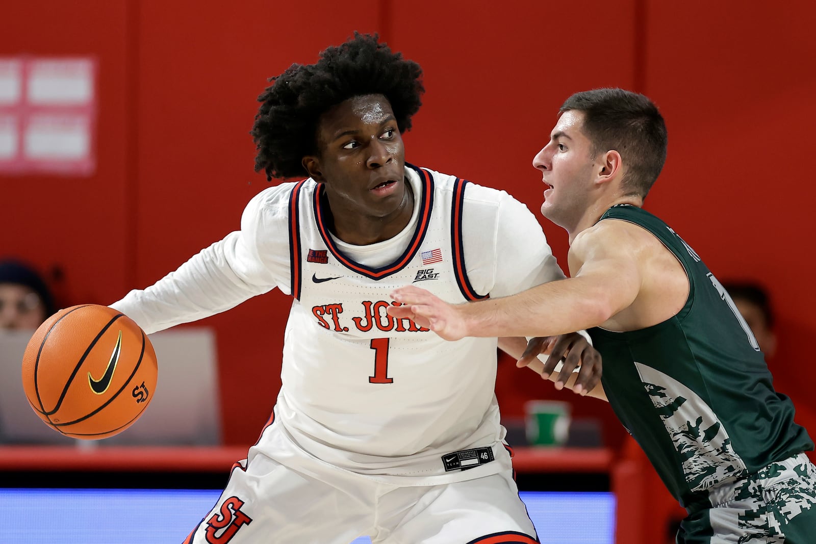 St. John's guard Kadary Richmond (1) looks to pass around Wagner guard Javier Ezquerra during the first half of an NCAA college basketball game Wednesday, Nov. 13, 2024, in New York. (AP Photo/Adam Hunger)