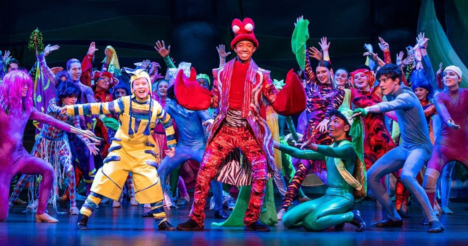 Mason Melvin (center as Sebastian) with Noah Mullen (left as Flounder) and the cast of Muse Machine's production of Disney's 'The Little Mermaid." CONTRIBUTED