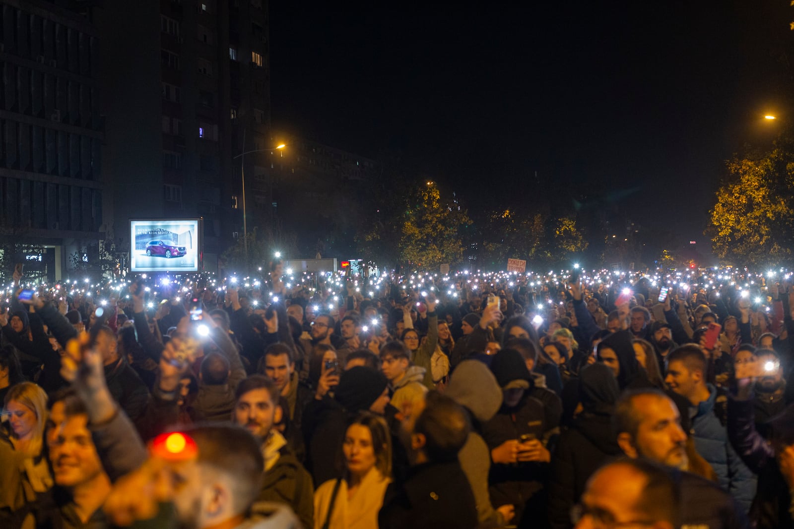 People light their mobile phones during a protest in Novi Sad, Serbia, Tuesday, Nov. 5, 2024. (AP Photo/Marko Drobnjakovic)