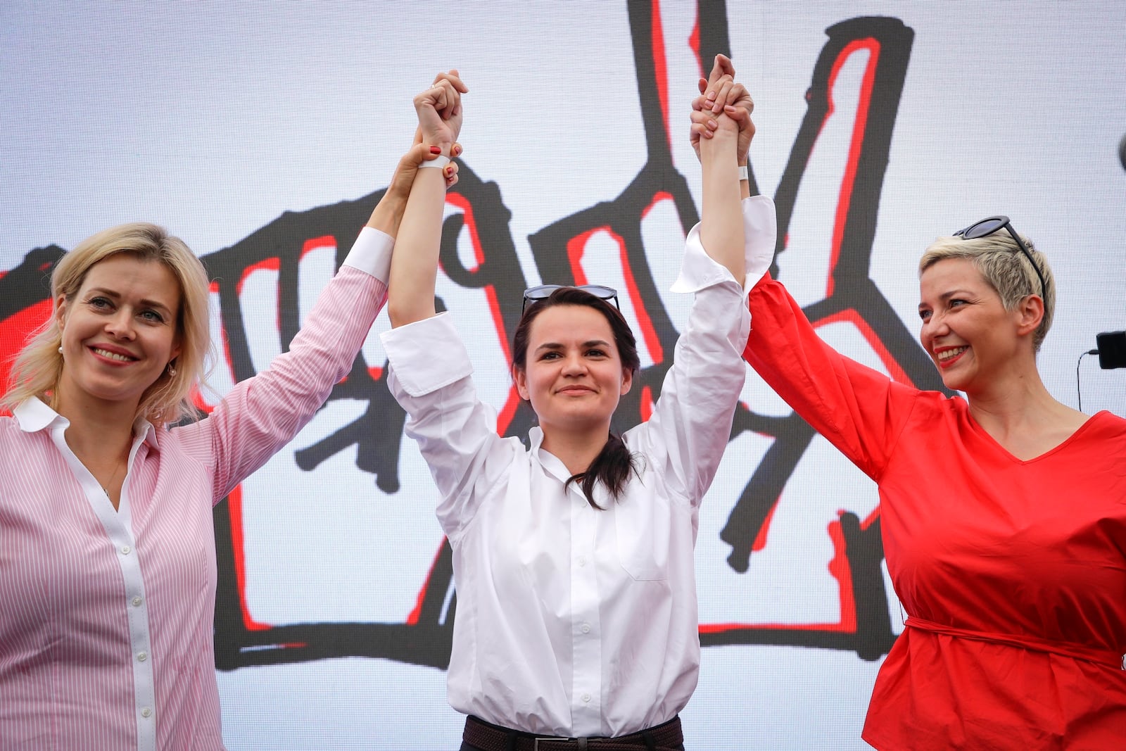 FILE – Activist Maria Kolesnikova, right, presidential candidate Sviatlana Tsikhanouskaya, center, and Veronkika Tsepkalo, left, wife of unregistered candidate Valery Tsepkalo, gesture at a rally in Minsk, Belarus, on July 19, 2020. (AP Photo, File)