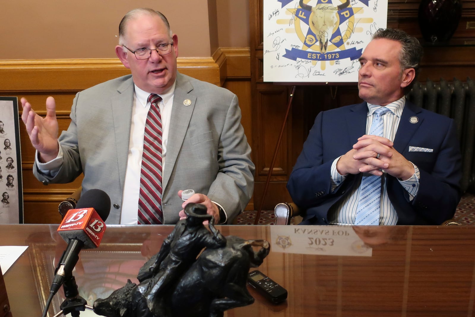 Kansas House Speaker Dan Hawkins, left, R-Wichita, speaks to reporters during a news conference following the annual State of the State address, as Senate President Ty Masterson, right, R-Andover, watches, Wednesday, Jan. 15, 2025, at the Statehouse in Topeka, Kan. (AP Photo/John Hanna)