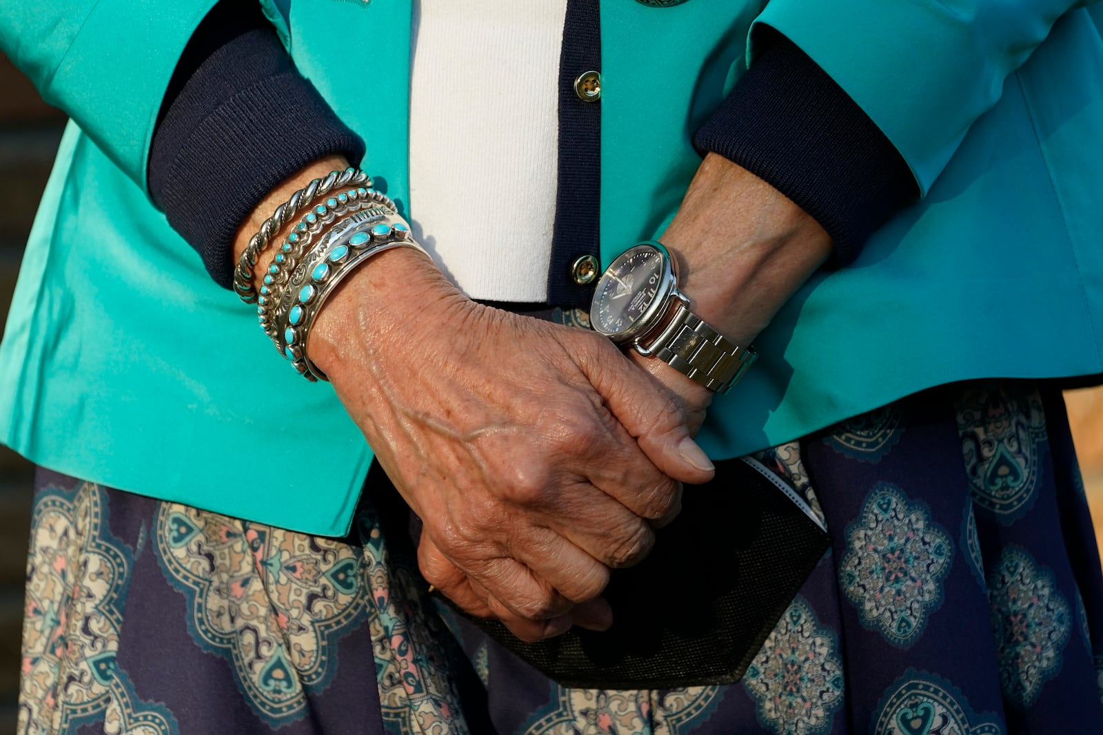 FILE - Secretary of the Interior Deb Haaland right wrist is adorned with various turquoise bracelets as she waits to address reporters about visiting several communities and sites in Mississippi to honor individuals and events that advanced the Civil Rights Movement, while standing outside the Medgar and Myrlie Evers Home National Monument in Jackson, Miss., Tuesday, Feb. 15, 2022. (AP Photo/Rogelio V. Solis, File)