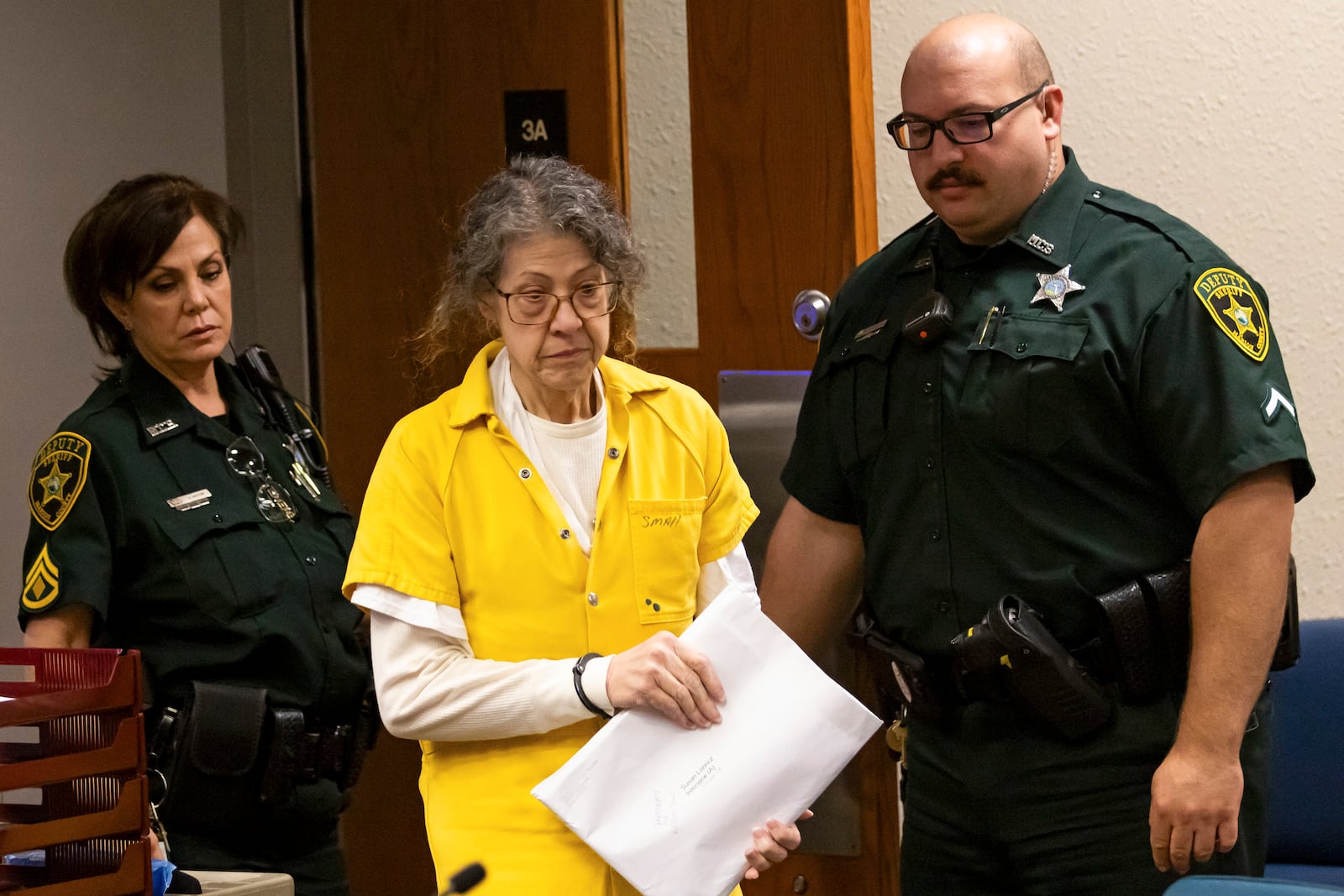 Susan Lorincz, center, who fatally shot a Black neighbor through her front door during an ongoing dispute, enters the courtroom for her sentencing hearing Monday, Nov. 25, 2024, in Ocala, Fla. (Doug Engle/Ocala Star-Banner via AP, Pool)