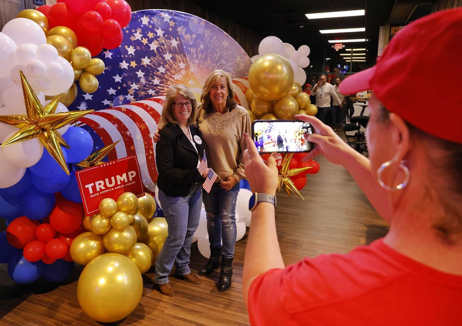 Amy Moore takes a photo of Vickie Barger, left, and Lisa Gase during the Butler County Republican Party election results watch party Tuesday, Nov. 5, 2024 at Lori's Roadhouse in West Chester Township. NICK GRAHAM/STAFF