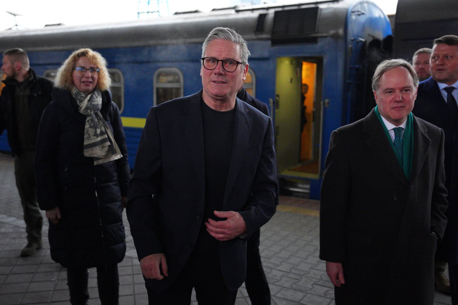 British Prime Minister Keir Starmer, center, is greeted by Ukrainian officials and the British ambassador to Ukraine Martin Harris, front right, as he arrives at a train station in Kyiv, Ukraine Thursday, Jan. 16, 2025. (Carl Court/Pool Photo via AP)