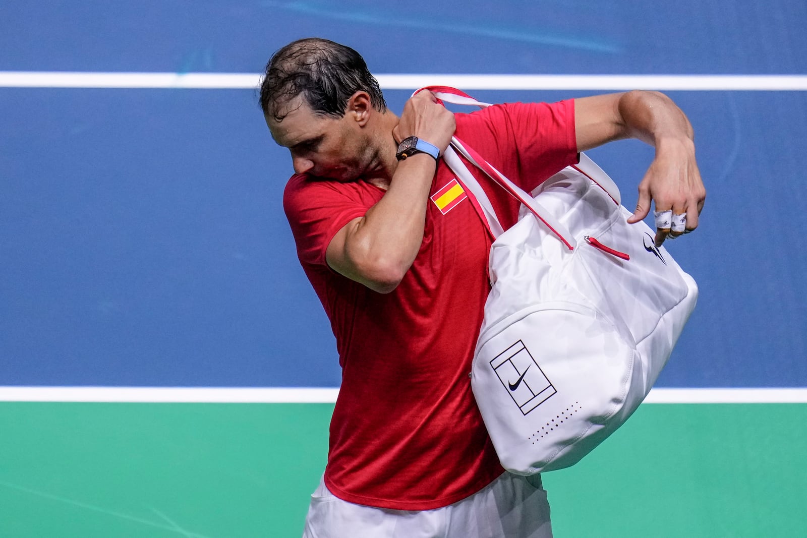 Spain's tennis player Rafael Nadal leaves the court after losing against Netherlands' Botic Van De Zandschulp during a Davis Cup quarterfinal match at Martin Carpena Sports Hall in Malaga, southern Spain, on Tuesday, Nov. 19, 2024. (AP Photo/Manu Fernandez)