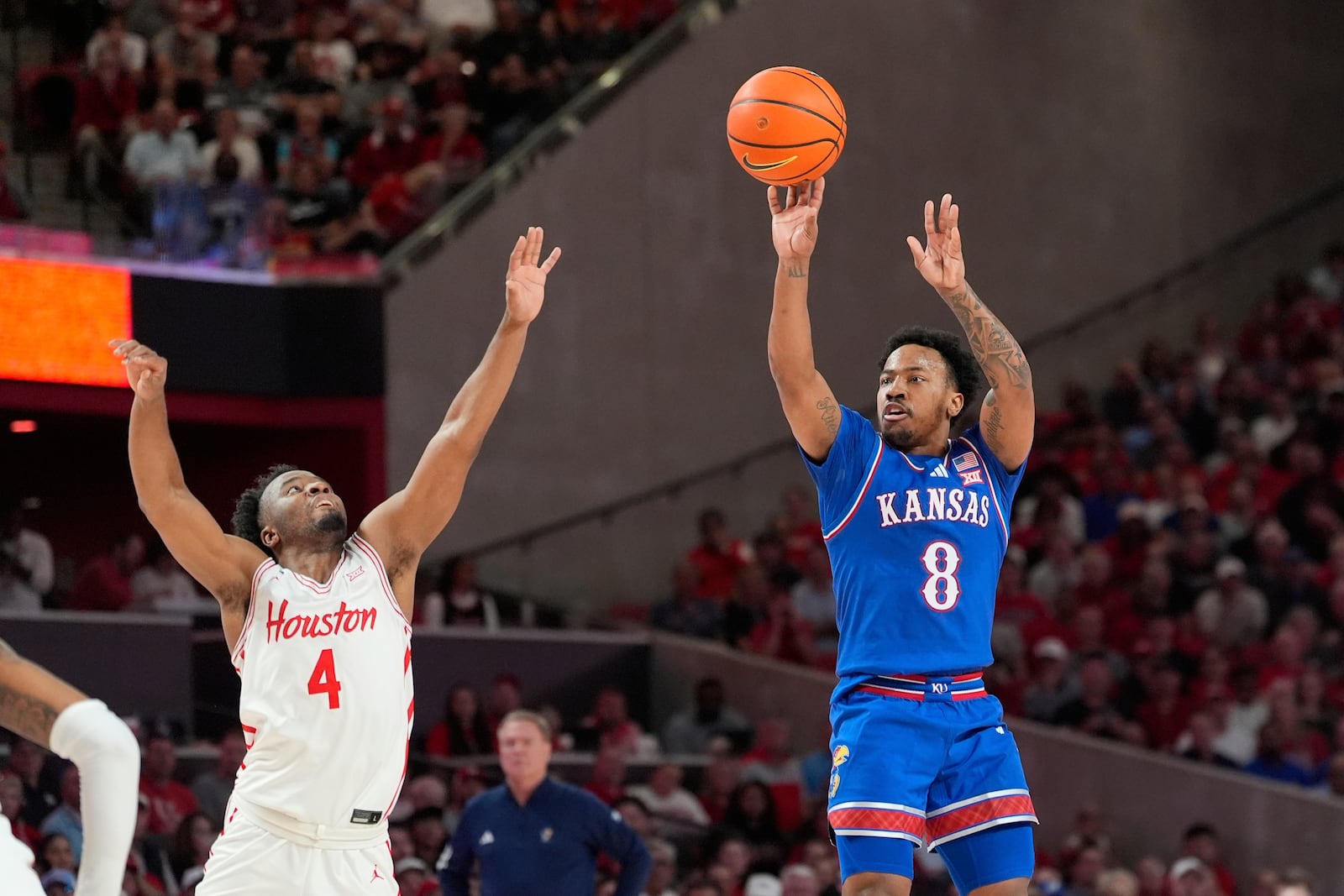 Kansas's David Coit (8) shoots as Houston's L.J. Cryer (4) defends during the first half of an NCAA college basketball game Monday, March 3, 2025, in Houston. (AP Photo/David J. Phillip)