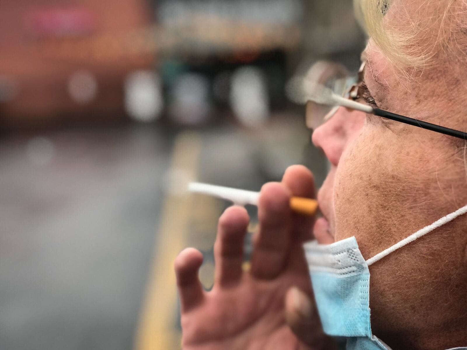 Jackie LaBrand, from Dayton, takes a smoke break on Brown Street on Monday afternoon October 19, 2020.