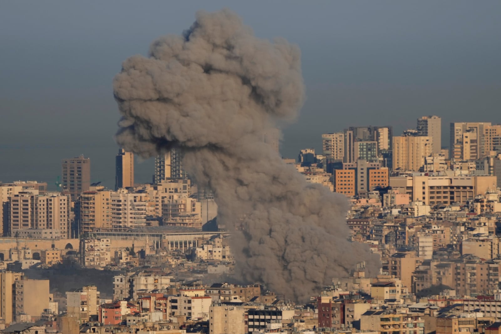 Smoke rises between buildings after an Israeli airstrike in Dahiyeh, in the southern suburb of Beirut, Lebanon, Friday, Nov. 15, 2024. (AP Photo/Hussein Malla)