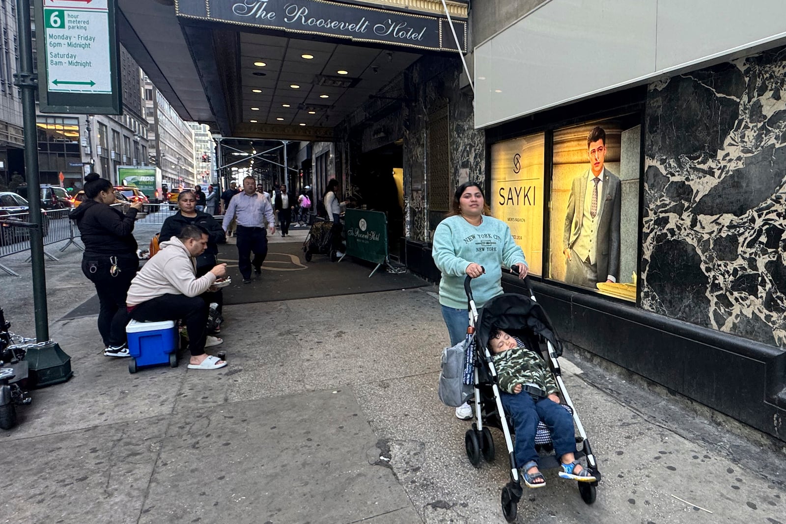 Maribel Hidalgo, 23, an immigrant from Venezuela, pushes a stroller carrying her son, Daniel, 2, outside the Roosevelt Hotel immigration shelter in New York on Wednesday, Nov. 6, 2024. (AP Photo/Cedar Attanasio)